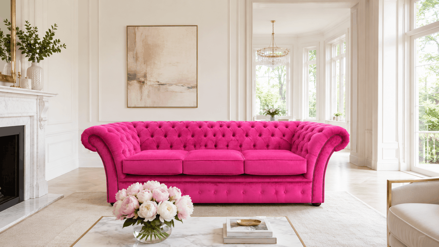 Bright pink velvet Chesterfield sofa in a light spacious room