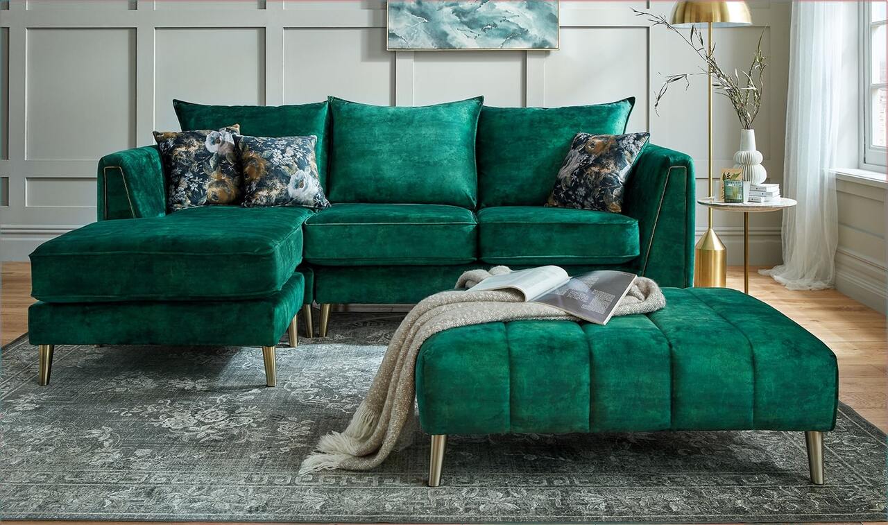 Emerald green corner sofa with matching footstool in a light panelled living room