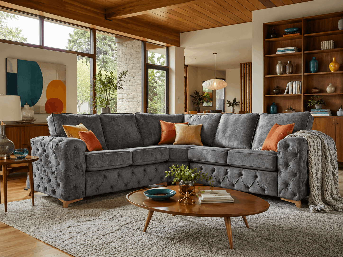 Grey fabric corner sofa with bright cushions in a mid-century living room