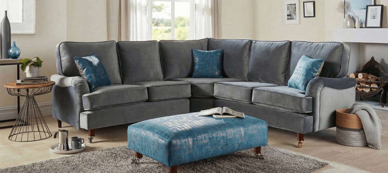 Grey Velvet Corner Sofa with Blue Accents in a Modern Lounge