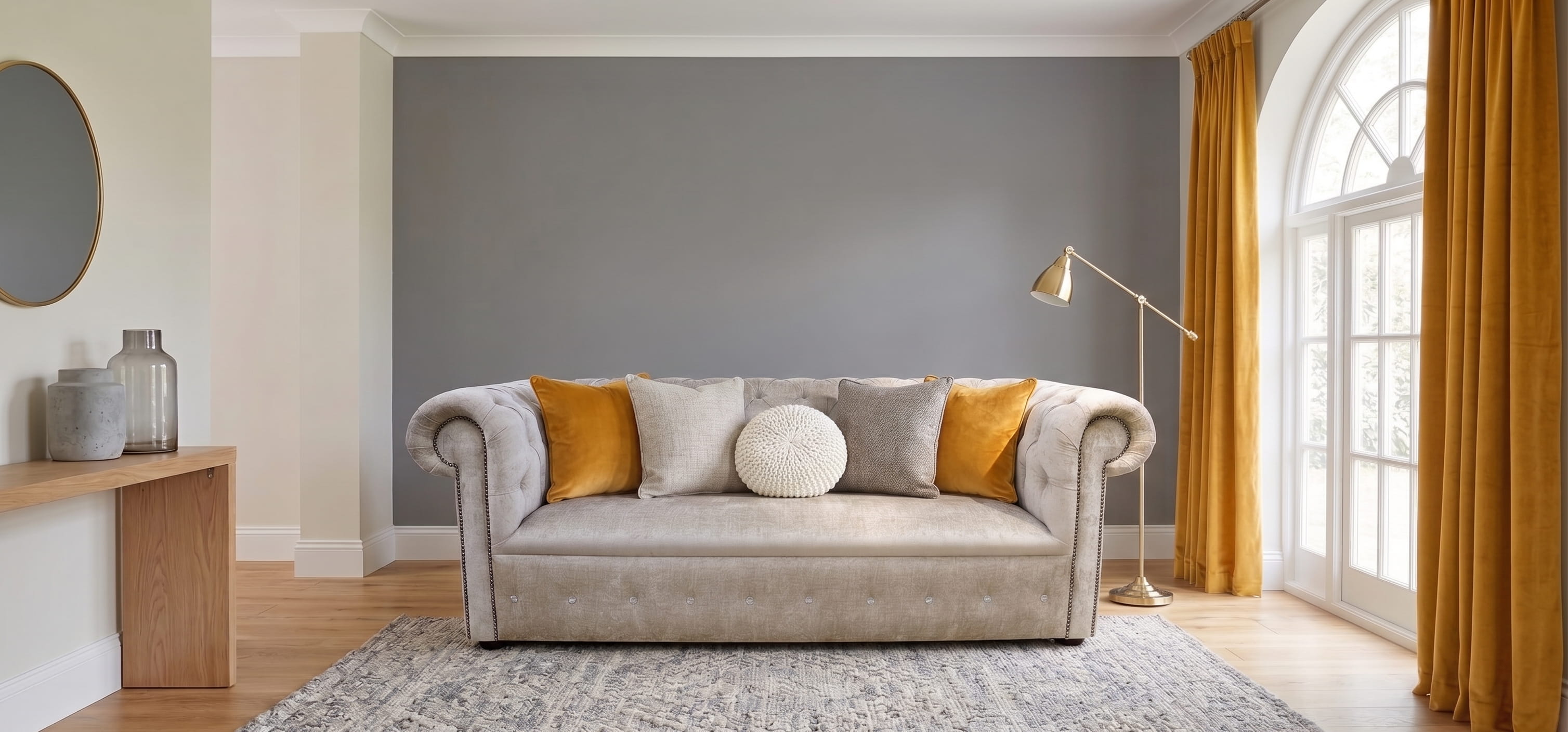 Mink Chesterfield sofa with mustard accents