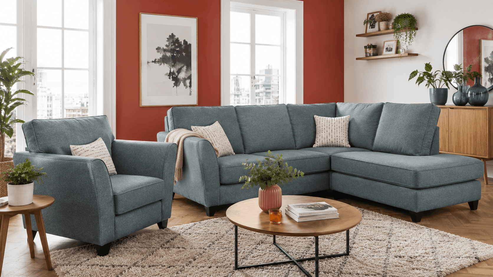 Teal fabric corner sofa and armchair against a terracotta accent wall
