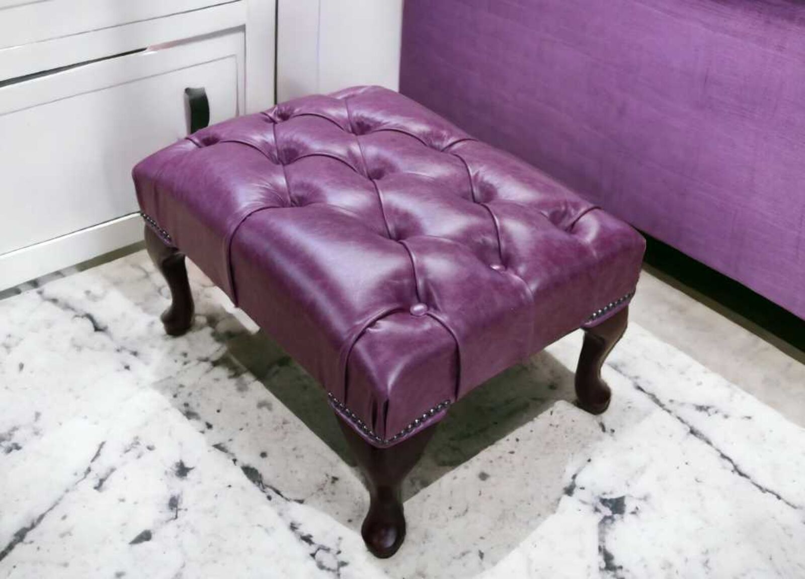 Product photograph of Chesterfield Queen Anne Footstool Uk Manufactured Old English Plum Leather from Designer Sofas 4U