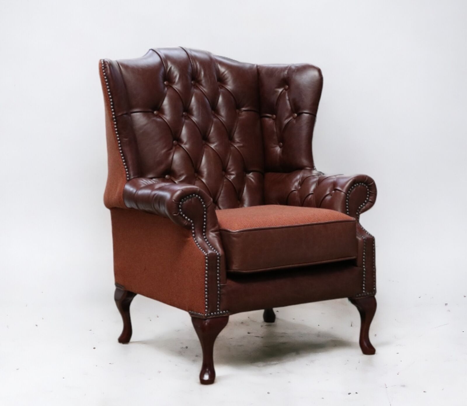 Product photograph of Chesterfield Ludlow High Back Wing Chair Newcastle Spice Leather And Carnegie Cinnamon Fabric from Designer Sofas 4U